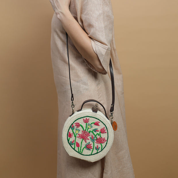 Lotus hand embroidered round jute bag