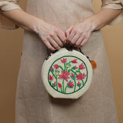 Lotus hand embroidered round jute bag