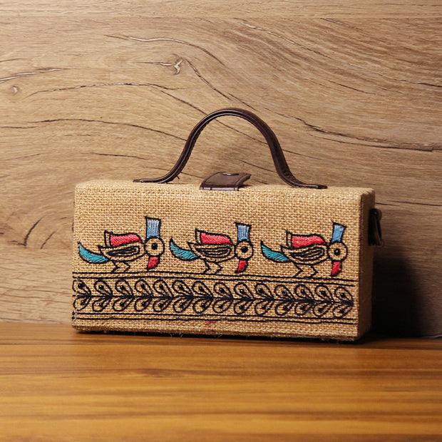 Madhubani Bird Hand Embroidered clutch bag (jute bag) by gonecase