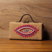 Evil eye hand embroidered jute clutch bag